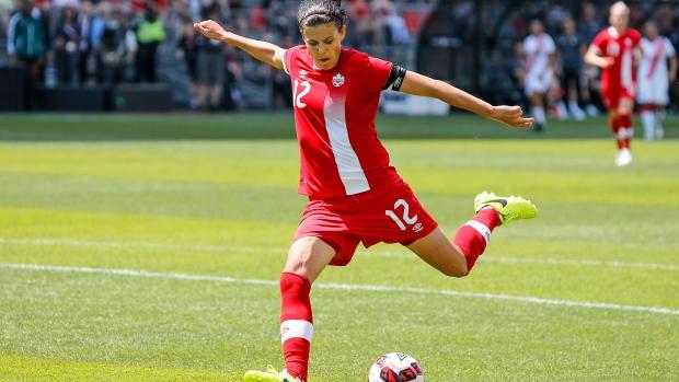 christine sinclair kicking a ball